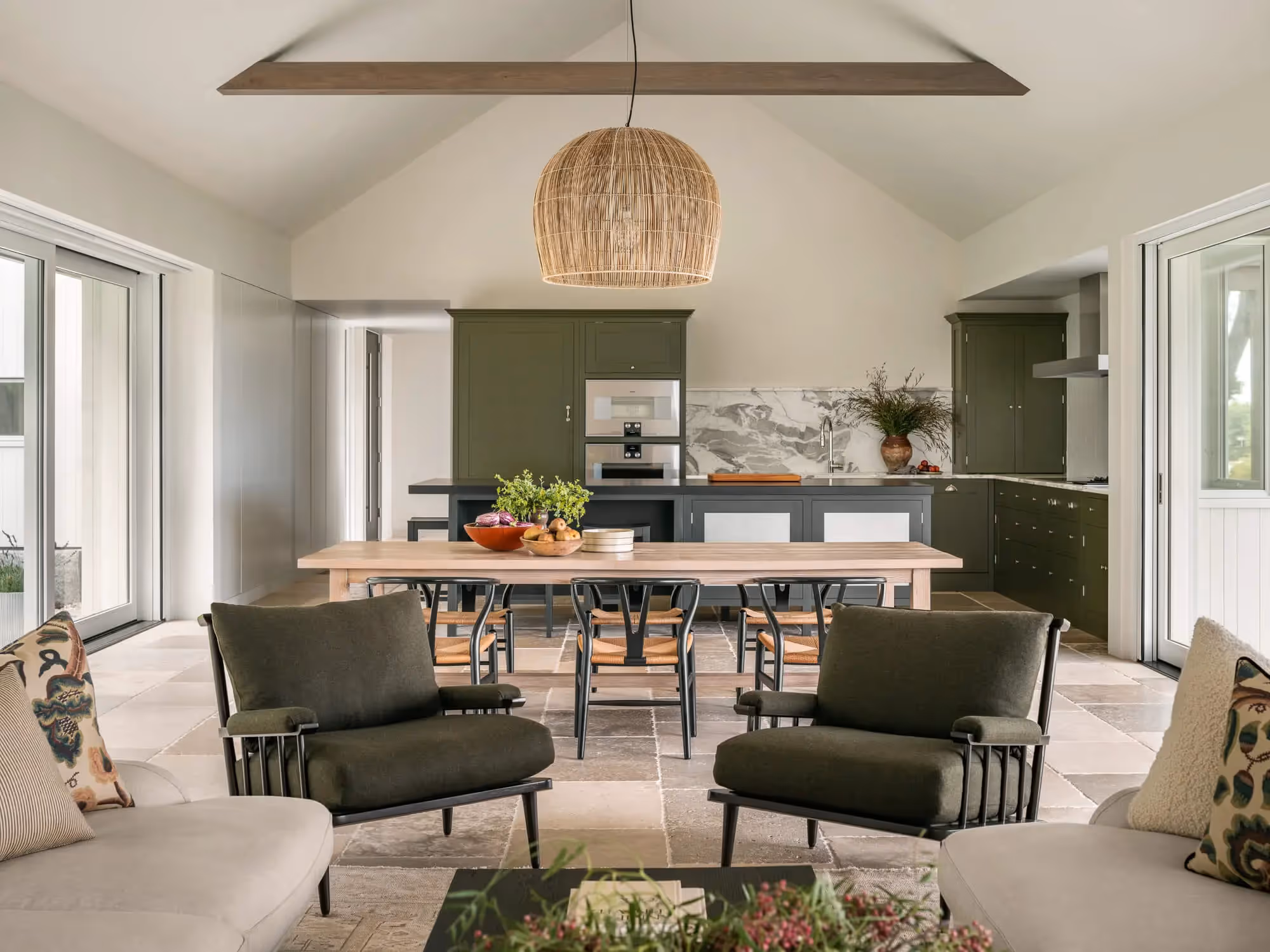 Modern open-plan kitchen and living space with olive green cabinetry