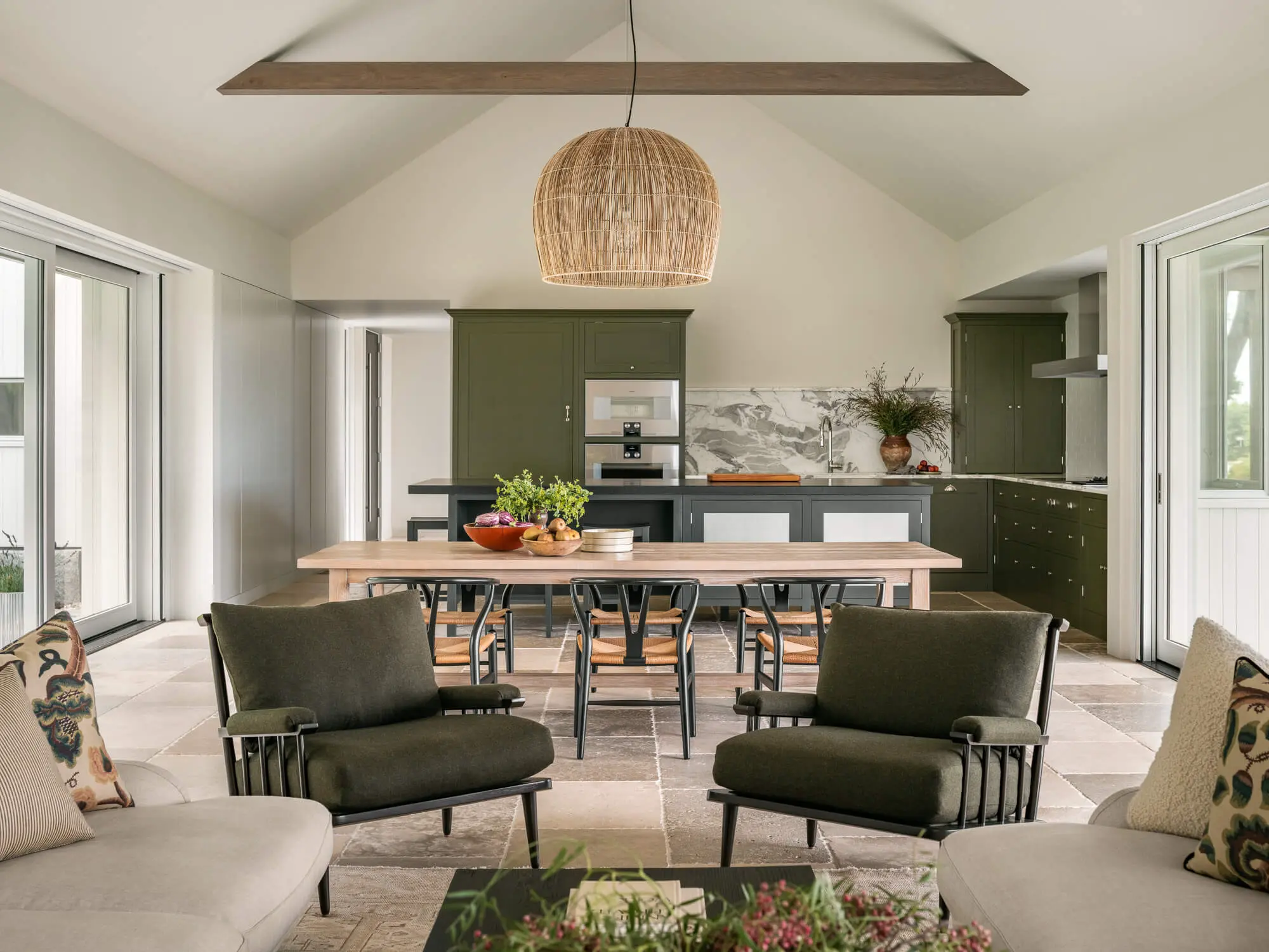 Modern open-plan kitchen and living space with olive green cabinetry