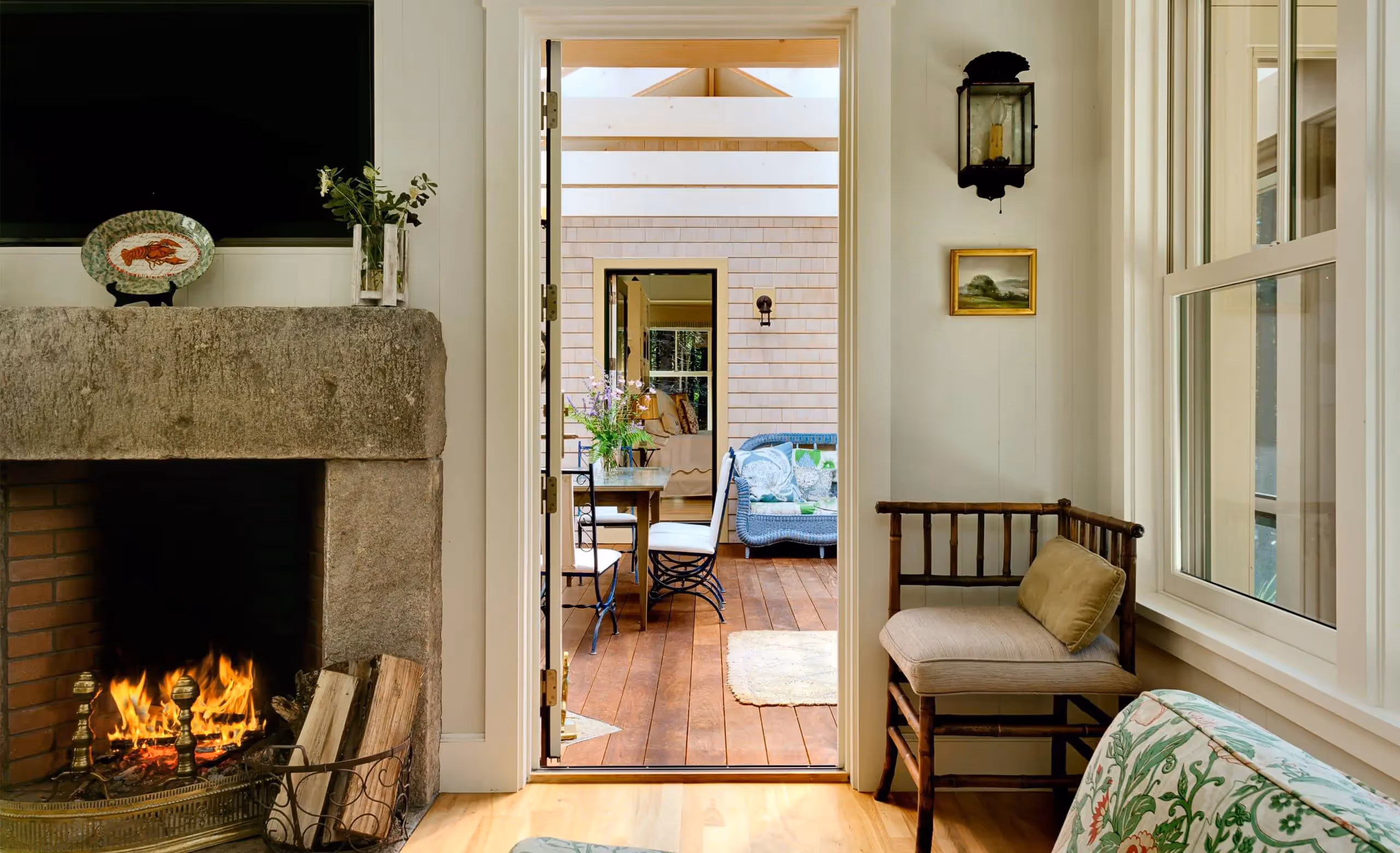 Cozy interior with fireplace, open door to wooden-floored room with furniture