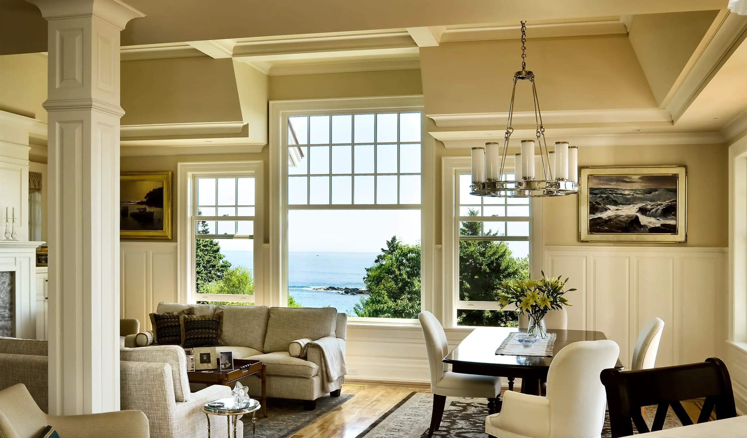 Coastal living room with ocean view, white windows, and elegant decor