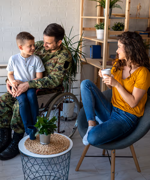 Wheelchair veteran sitting with family