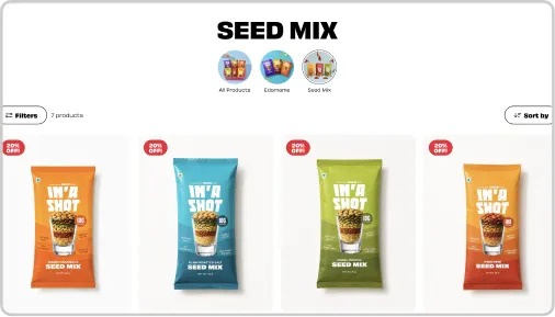 Four seed mix snack bars in orange, blue, green, and red packaging labeled 'I'm a Shot' with 20% off tags.