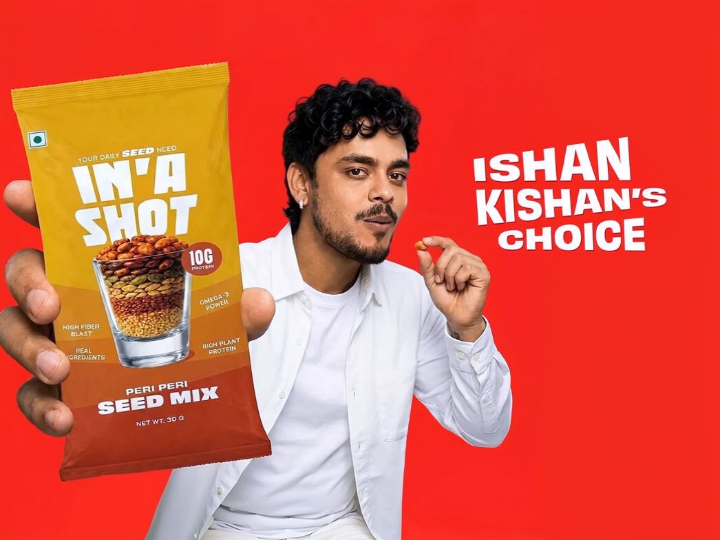Ishan Kishan holding an In'A Shot seed mix pack