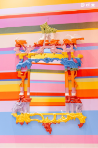 A colorful mirror on a striped surfaceAI-generated content may be incorrect.