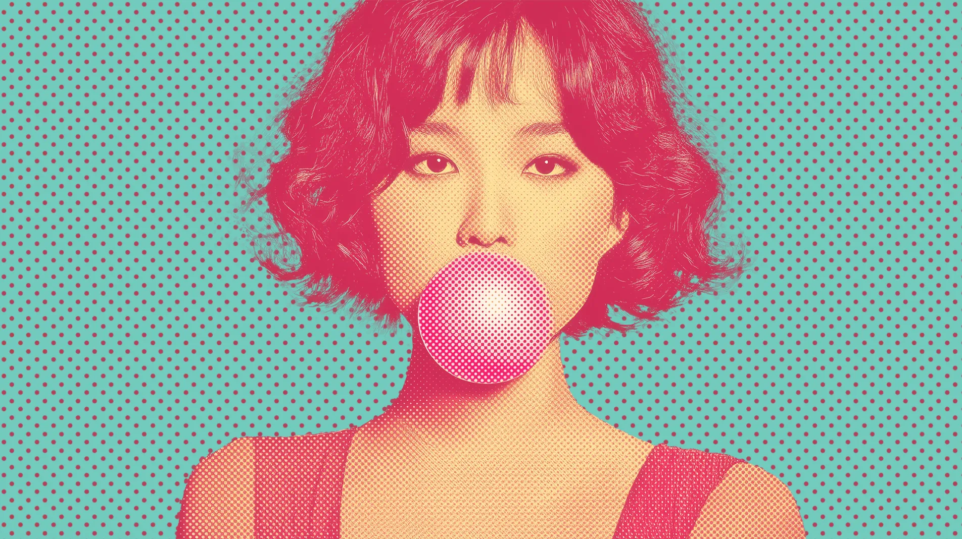 女性がピンクのガムを膨らませる画像