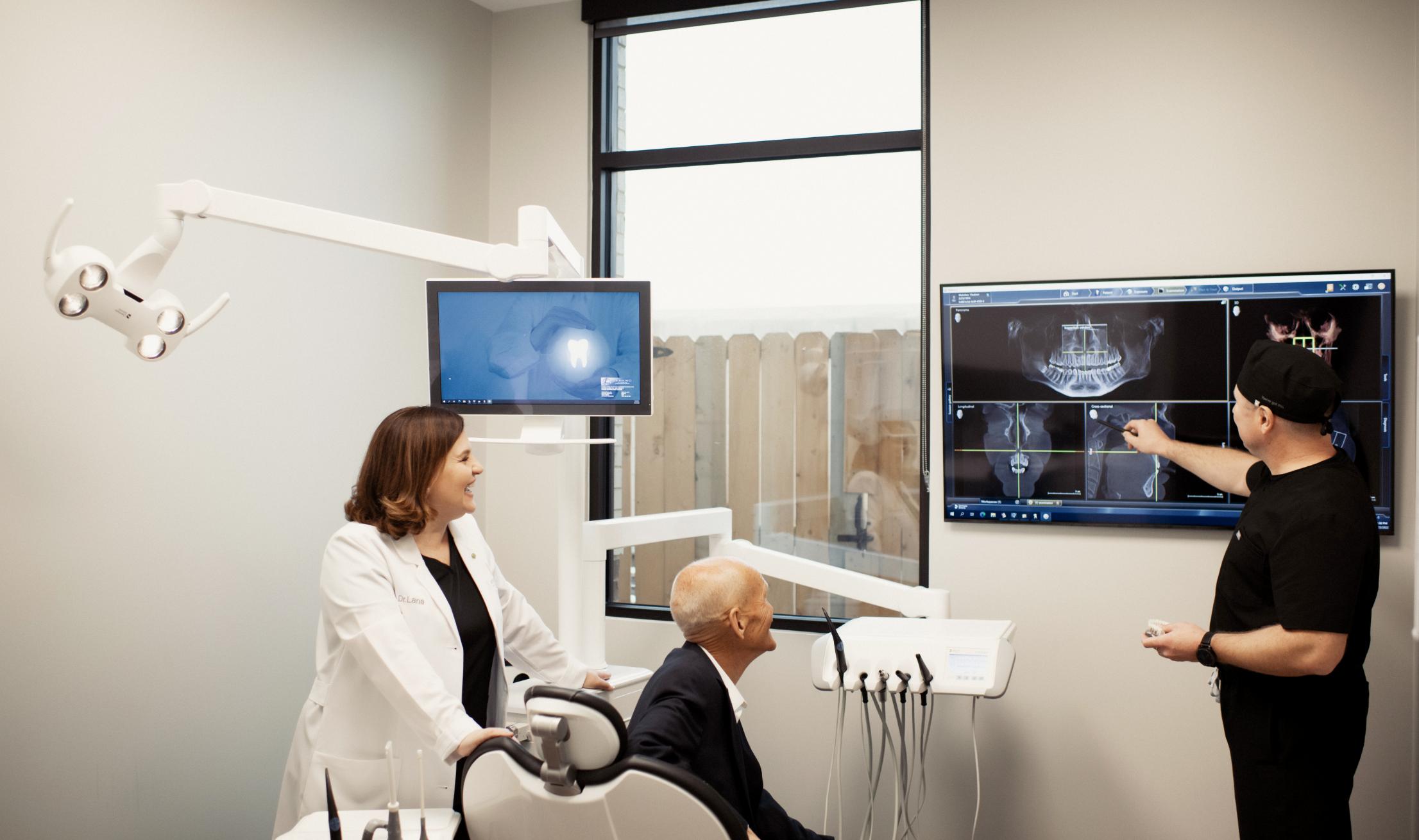 Dr VLADIMIR MELNIKOV and Dr SVETLANA USHERENKO showing male patient his x-ray