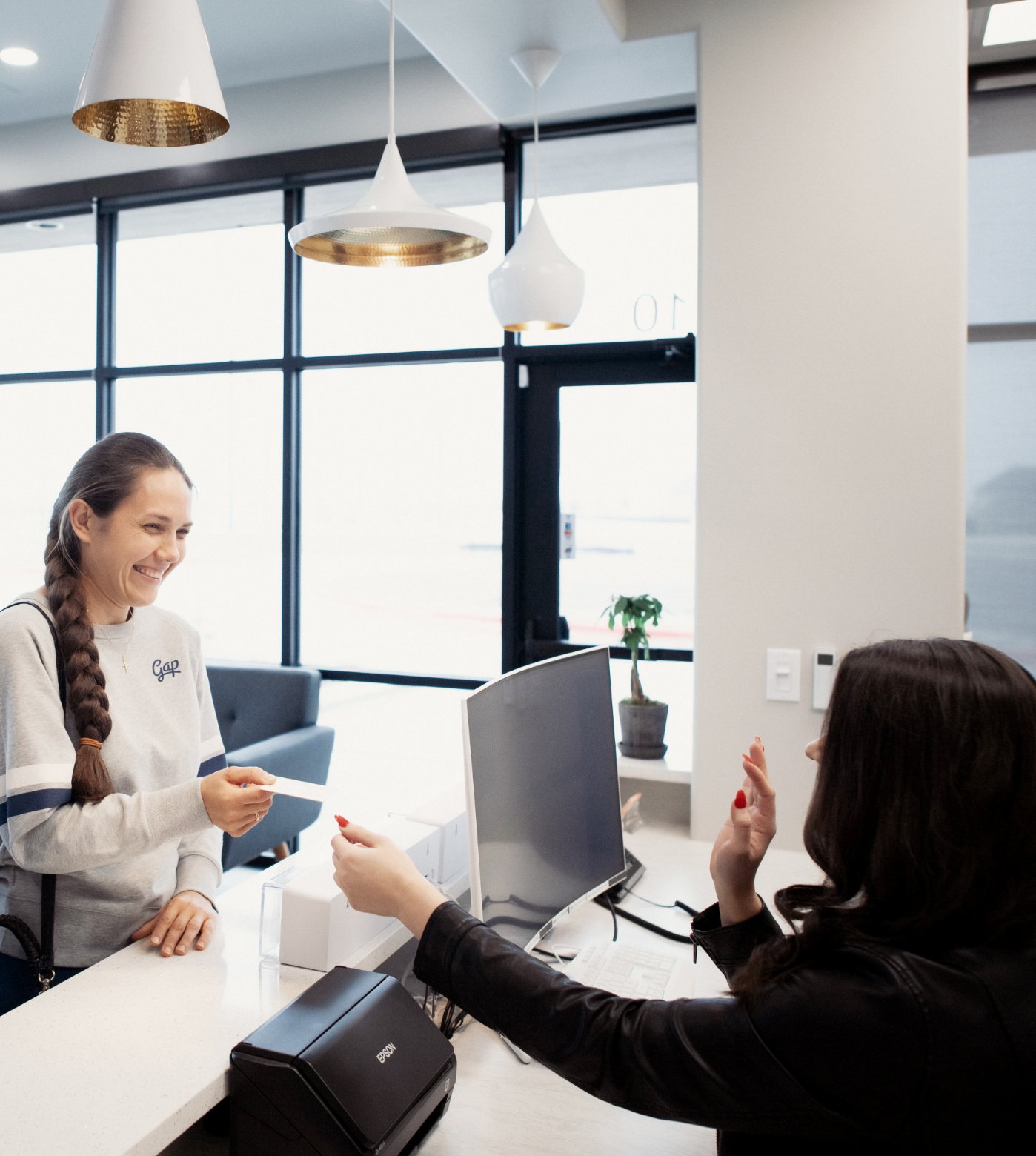 Front desk receptionist checking in patient