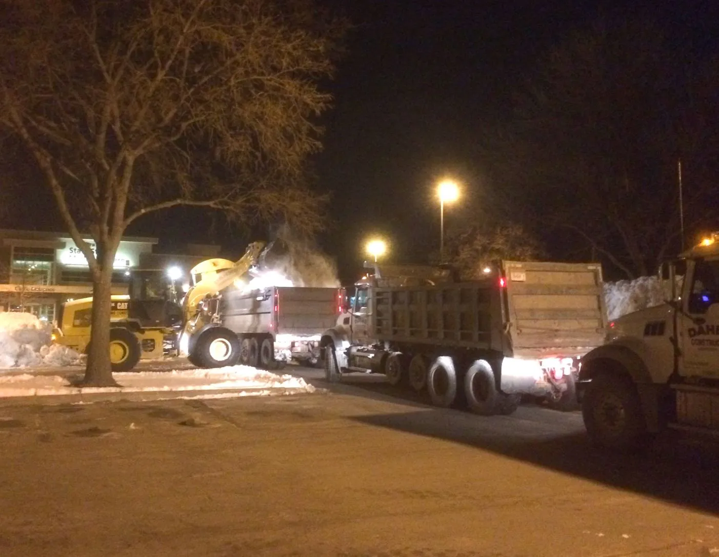 Loader removing snow from parking lot