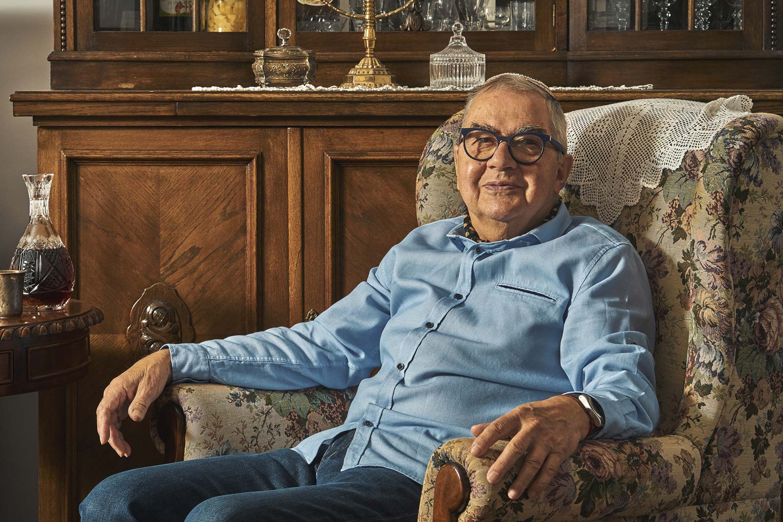 Senior Jew sitting in armchair in traditional home