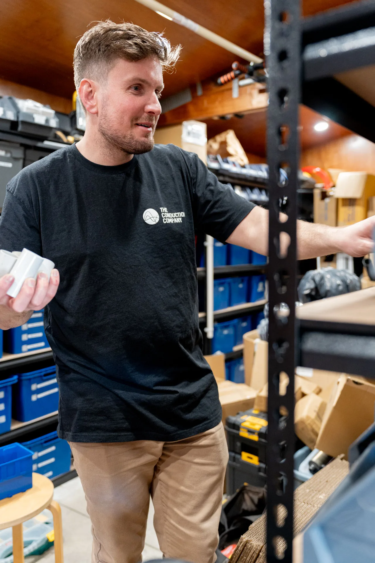 Jordan Statham picking fittings from a storeroom shelf