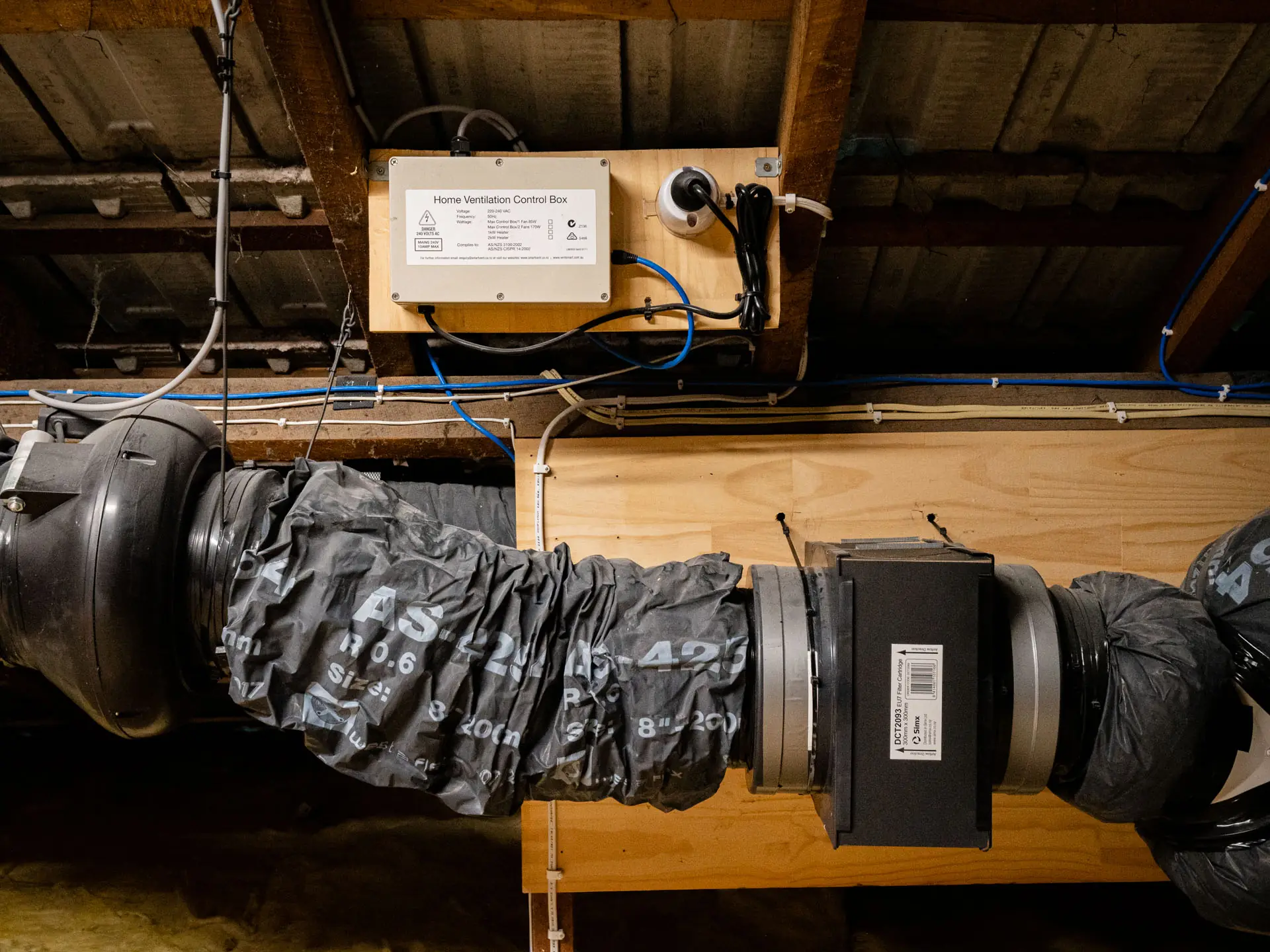 Technician mounting a heat pump on a wall