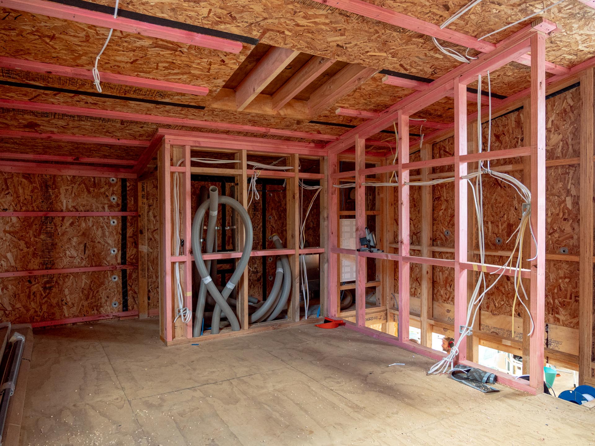 Timber framed room at pre wire stage, with cable and conduit run through the wall studs.