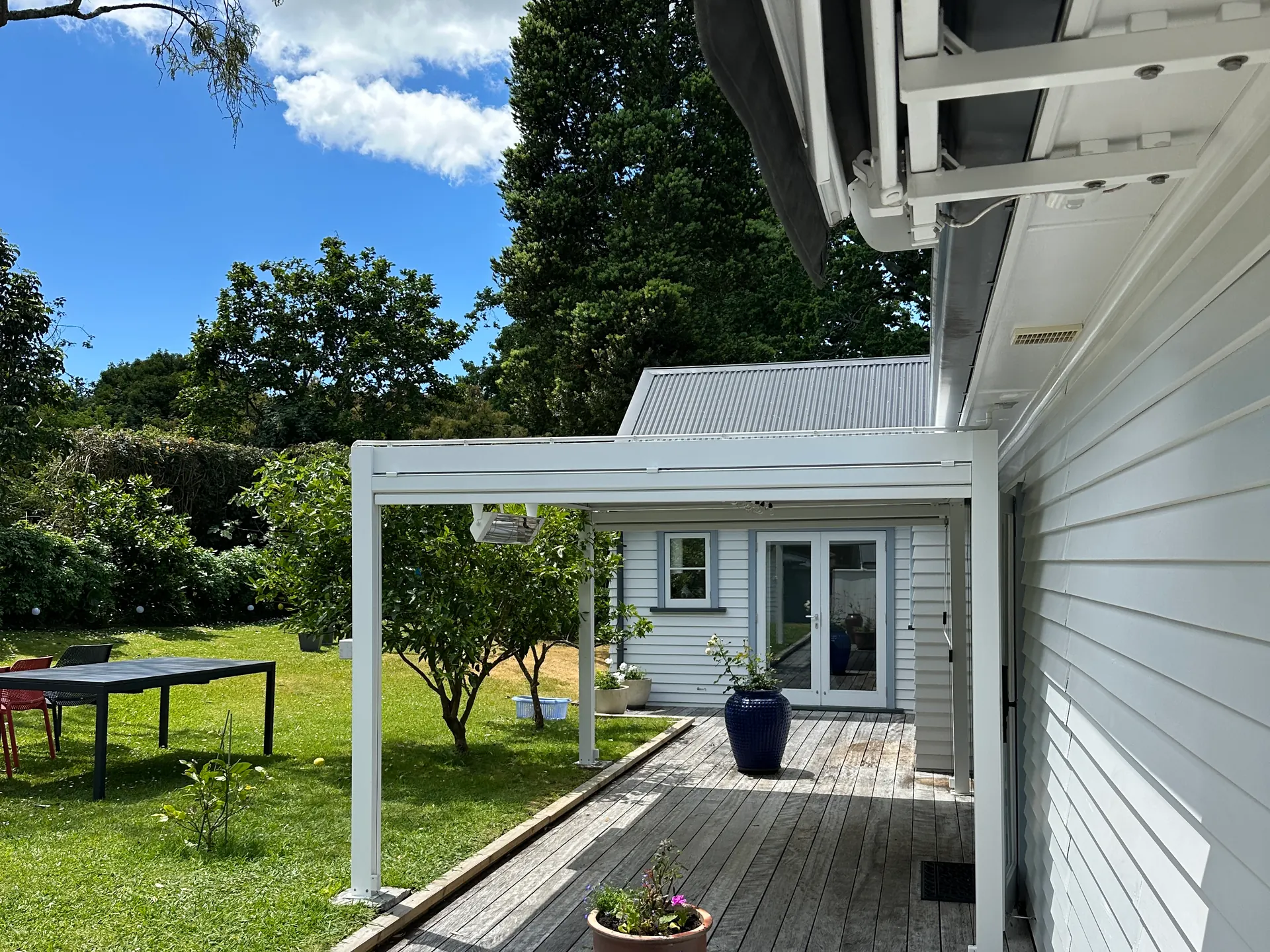 Electric infrared heater mounted under the soffit of a covered deck