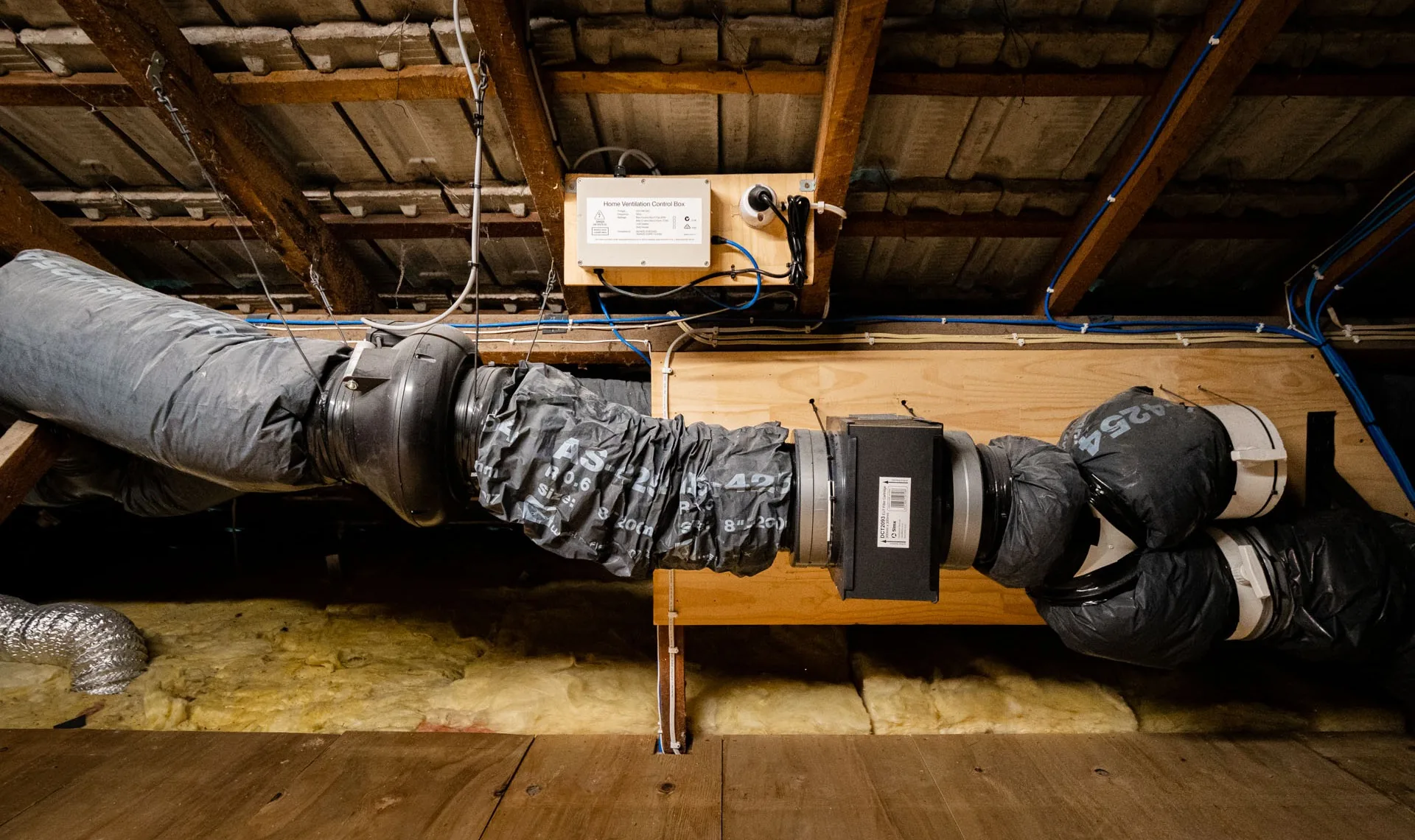 A home ventilation system in a roof space, with insulated ducting, a filter box and a control unit
