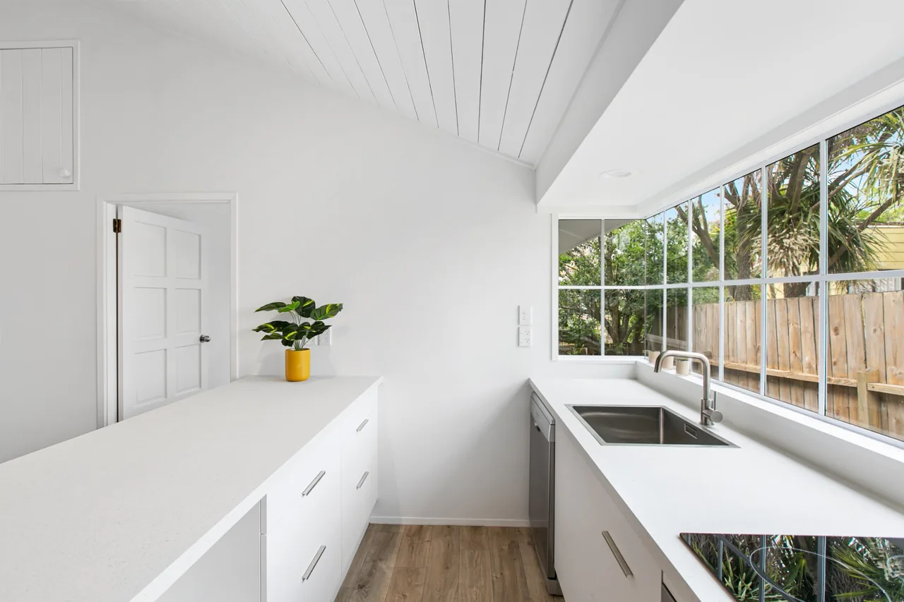 Galley kitchen bench to a corner window, with a double power point and switch on the end wall and a downlight in the bulkhead