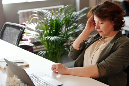 Woman at desk unhappy 