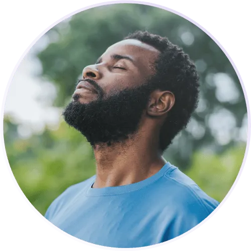 a man with his eyes closed looking up