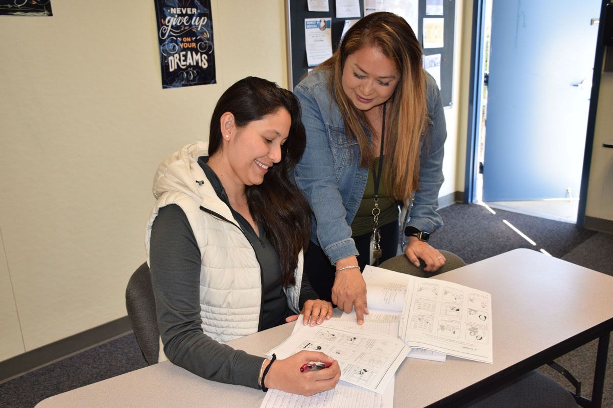 Two women collaborating and studying together in an office
