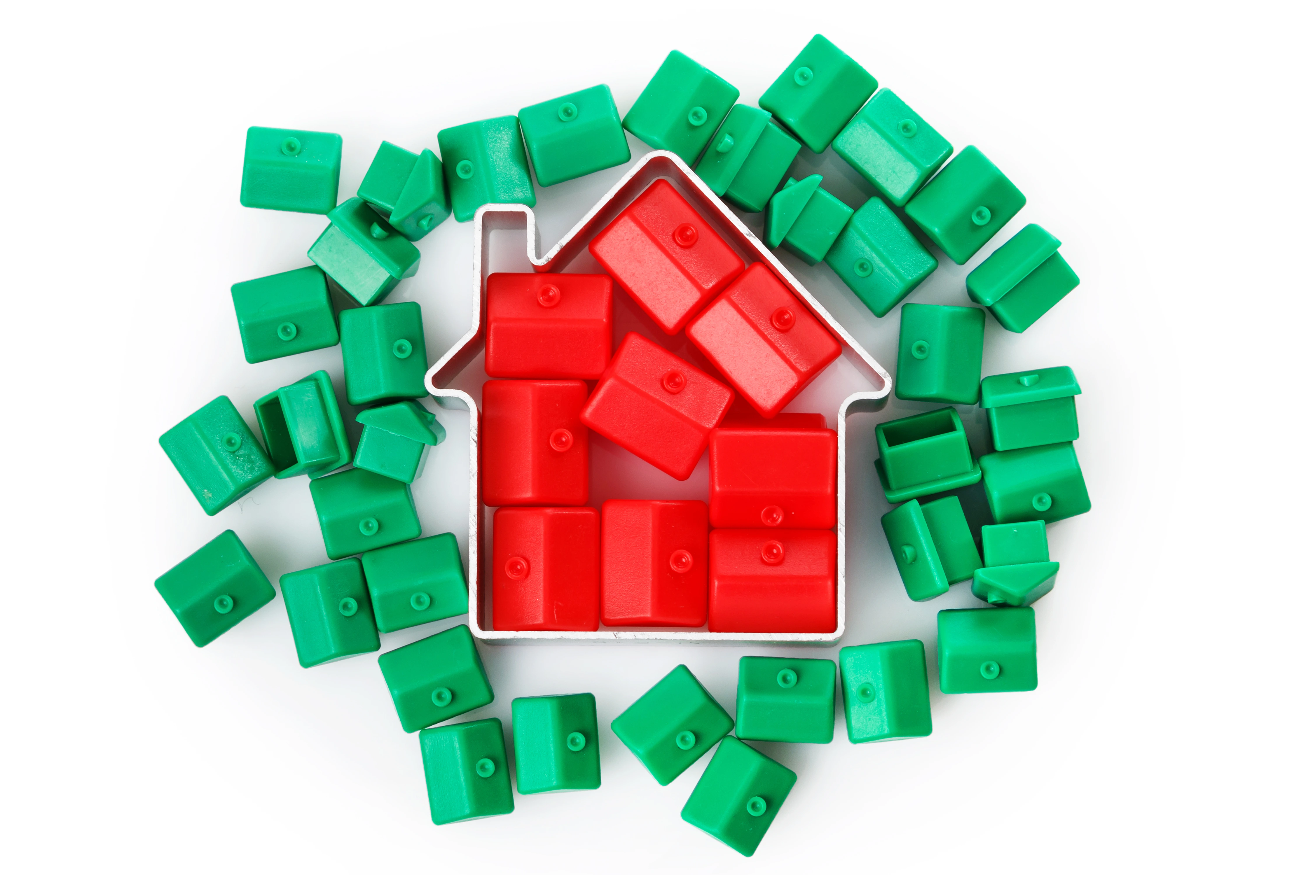 Small red and green houses on a white background