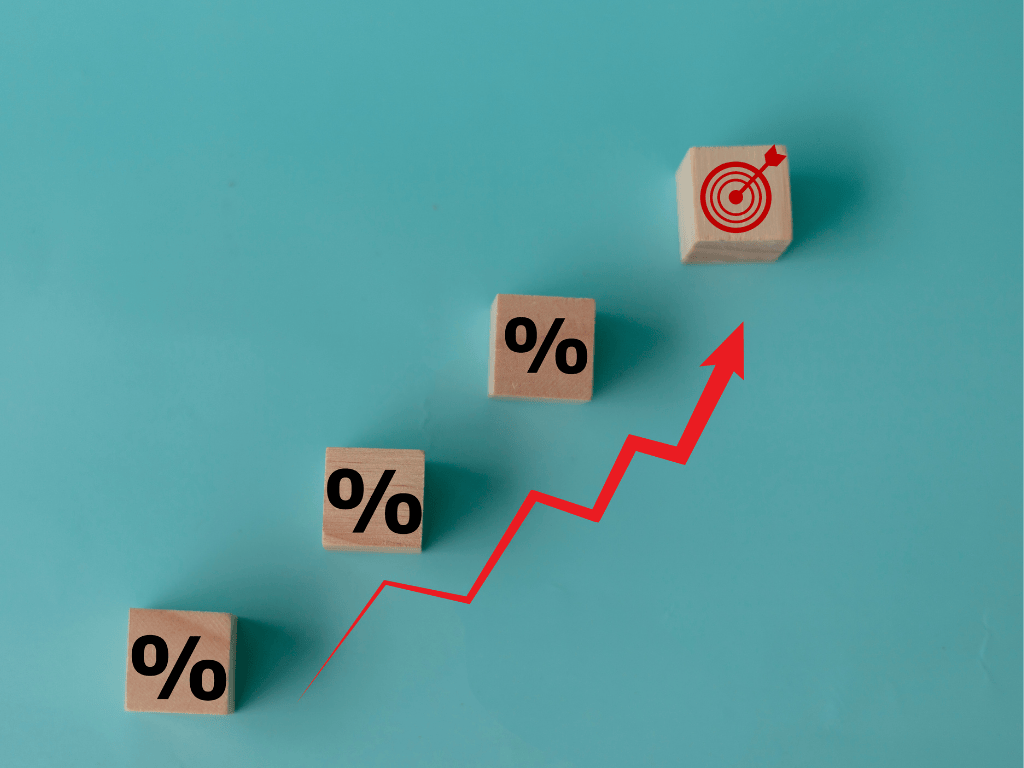 Image showing a rising chart with percentage signs alongside it to convey rising interest rates. 