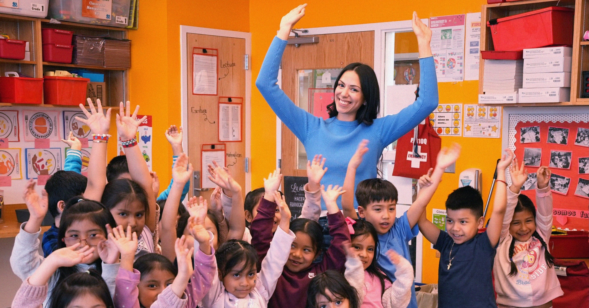 Photo of a teacher and students in their classroom