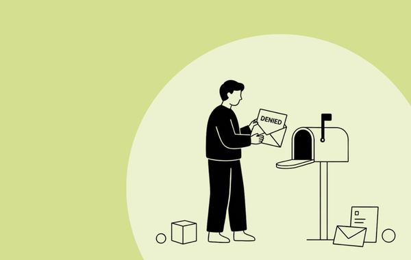 man at mailbox receiving 'Denied' letter