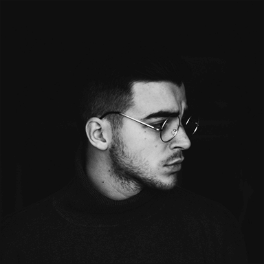 man wearing black turtleneck top and silver framed eyeglasses