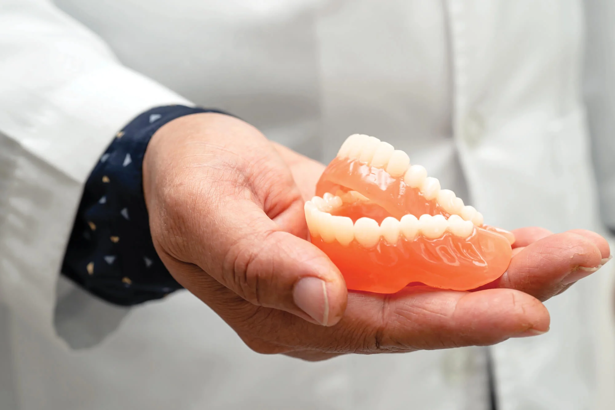 Holding complete Denver dentures