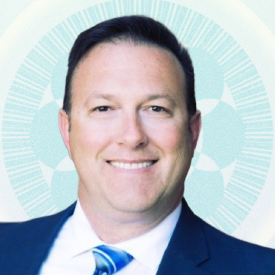 Headshot of Managing Director John Scambray against tan background