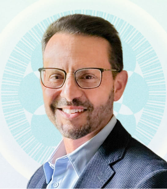 Headshot of Managing Director John Scambray against tan background