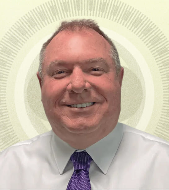 Headshot of Managing Director Daniel R. Gilham against tan background