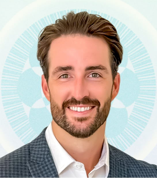 Headshot of Keith Sauls against blue ripple background