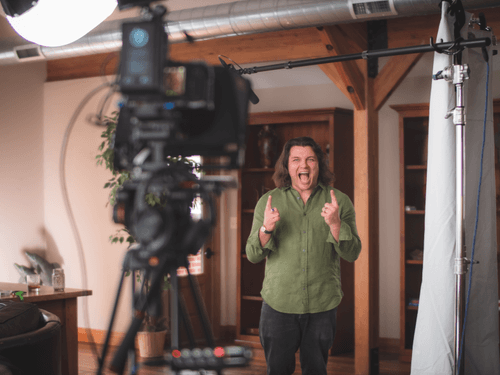 A man giving a thumbs up in front of a camera