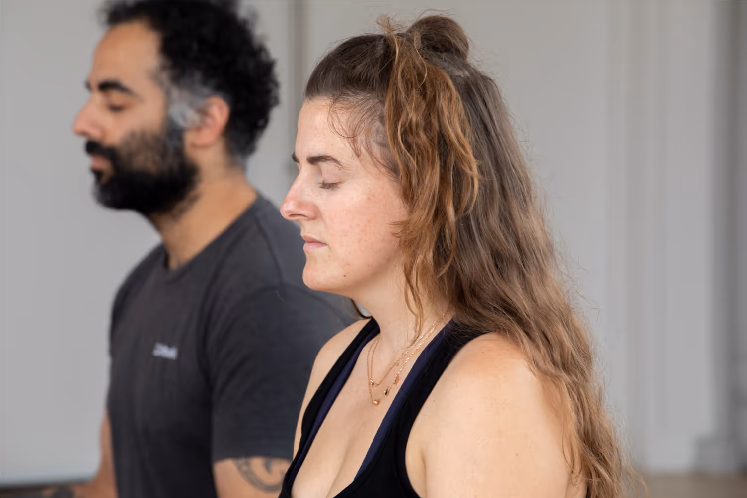 two people practising breathing work for relaxation