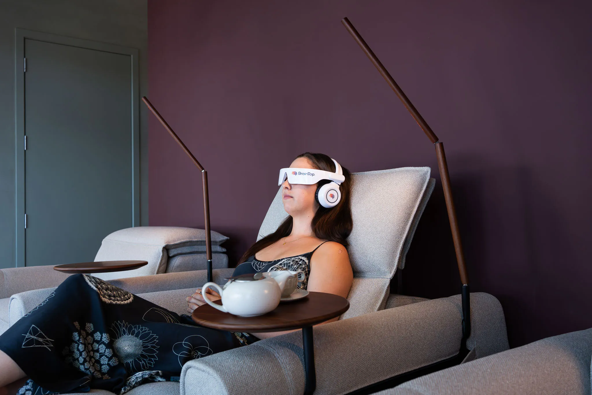 Women relaxing on a recliner using the BranTap tech in auckland remuera