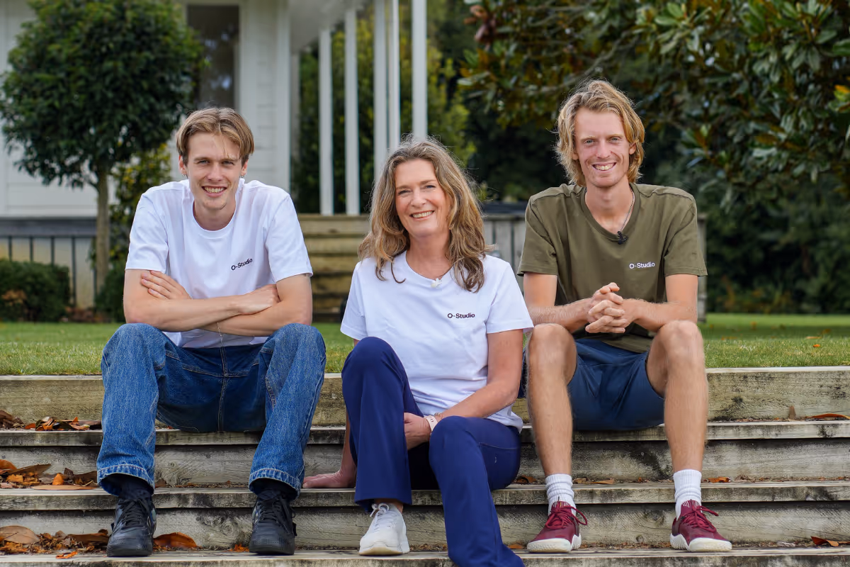 O-Studio Remuera owners sitting on stairs outside smiling 