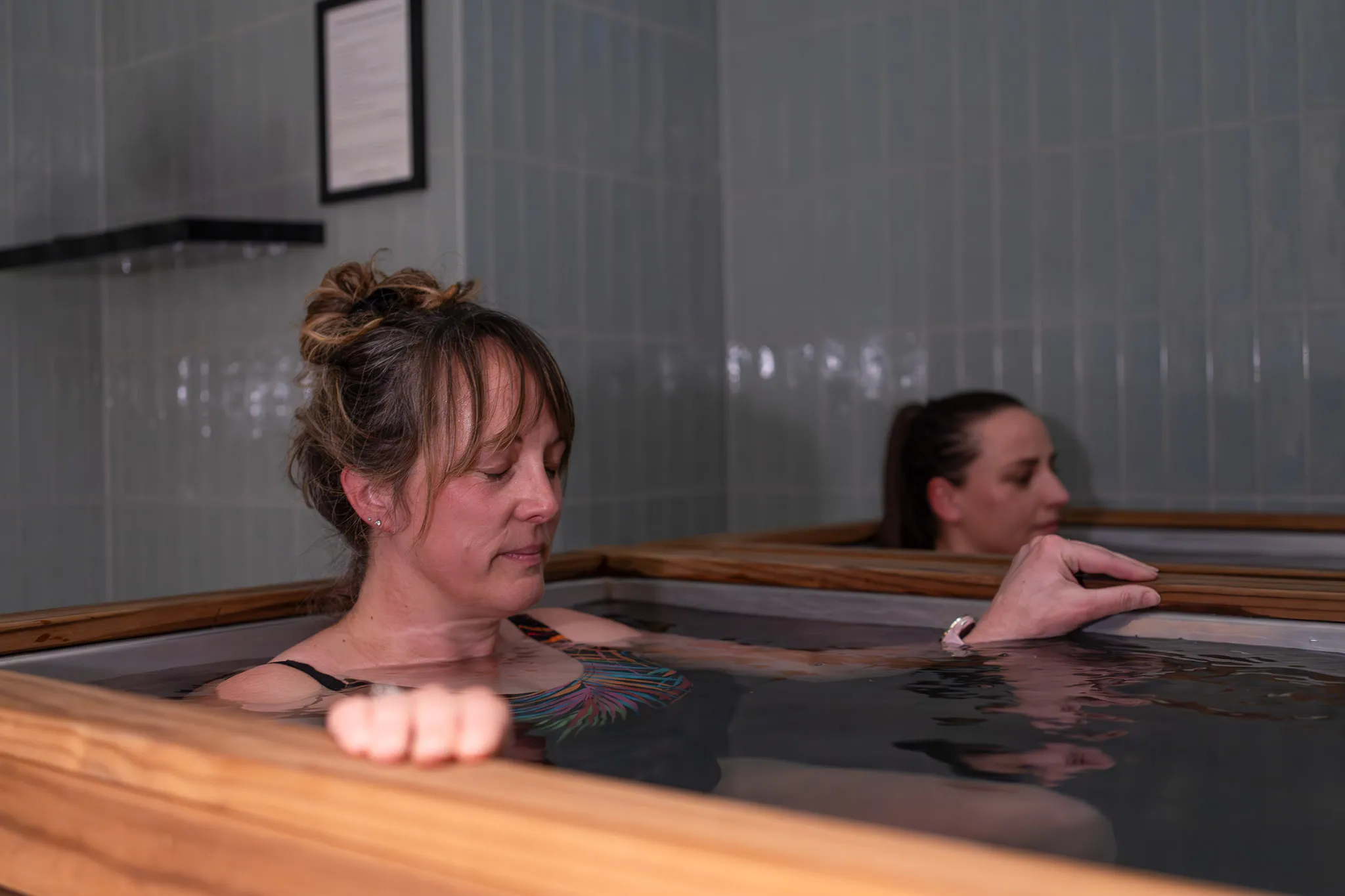 Women sitting in O-Studio Remuera Communal Sauna
