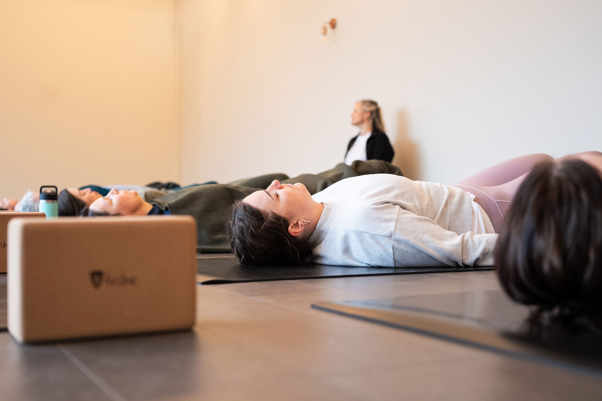 Women sitting in O-Studio Remuera Communal Sauna