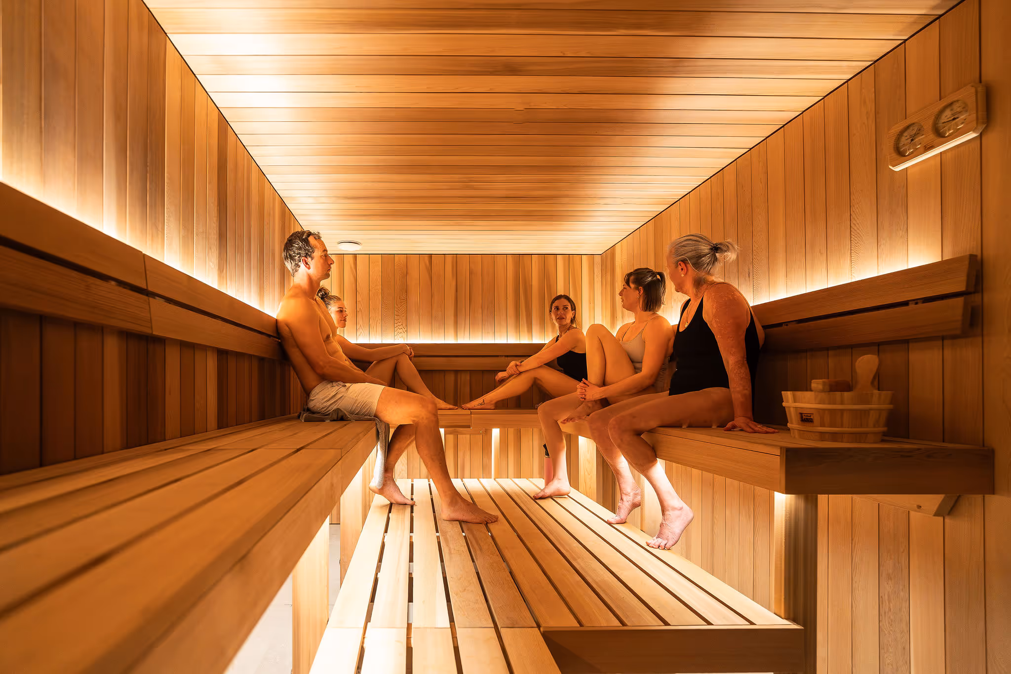 room covered in stone titles with a shower and sauna