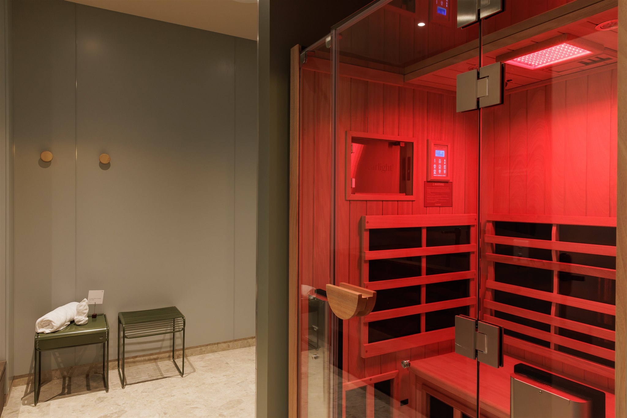 Women sitting in a large ice bath in Remuera with her eyes closed.