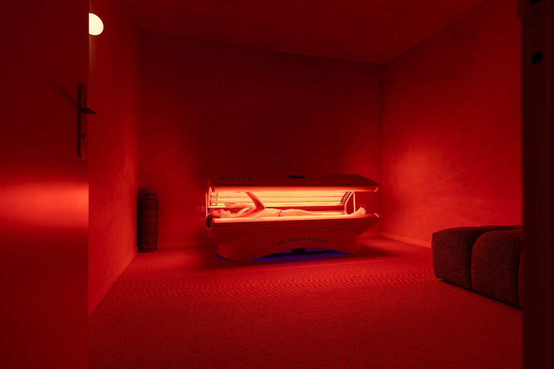 man sitting in ice bath in Remuera O-Studio with her hand on your heart