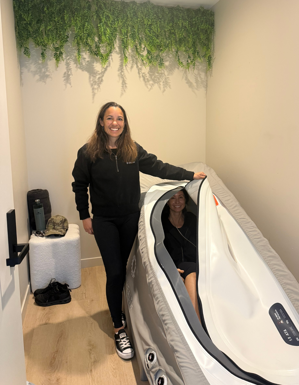 Four people sitting and talking in a communal sauna in Remuera
