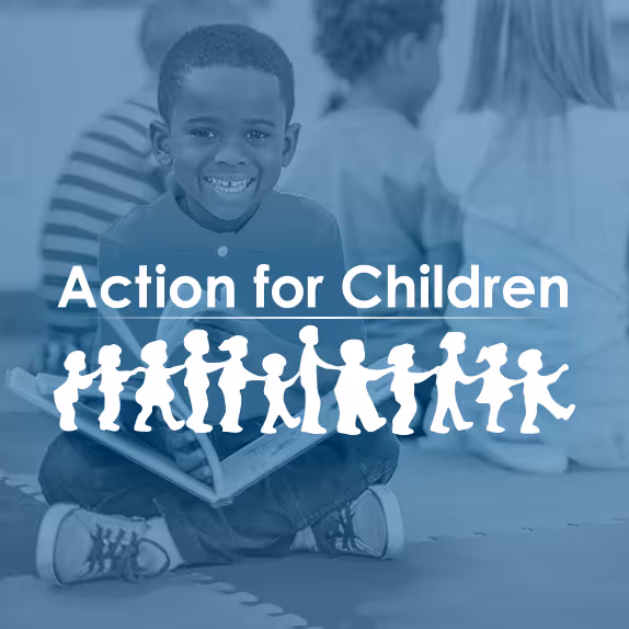 Image of a young Black boy sitting on the floor with a book in his lap and smiling overlaid with the Action for Children logo