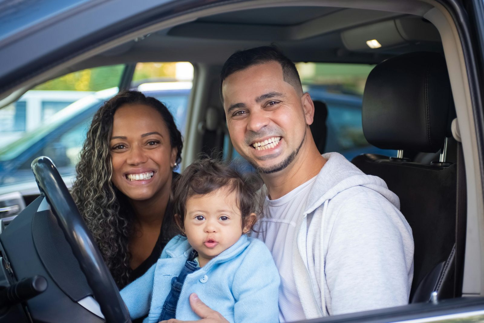Family purchasing a vehicle, representing how more accurate loan-level underwriting expands approvals while maintaining disciplined portfolio performance.