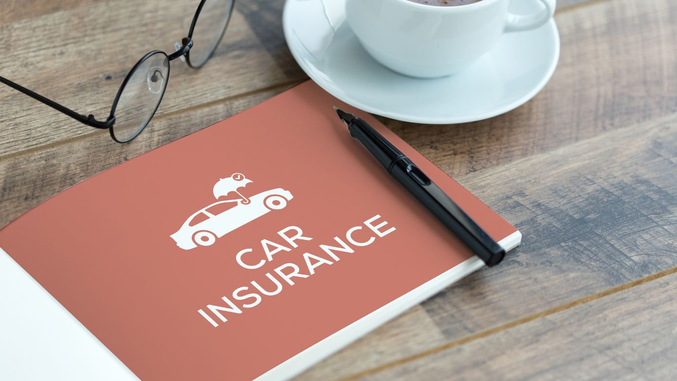 Insurance booklet on table with glasses