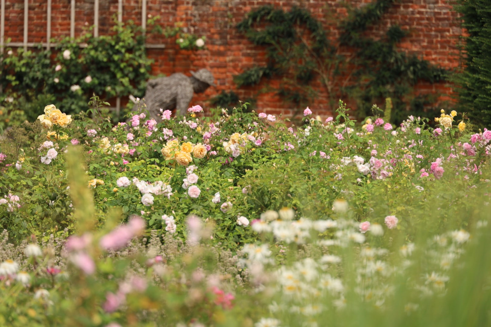 Hampton Court Palace Rose Garden, A Decade Among Hampton Court's Roses: An Intimate Journey Through England's Most Romantic Garden, London rose garden, Rose garden in full bloom at Hampton Court, Bark statue of the gardener by Tessa Hayward inside Rose Garden at the Hampton Court Palace, London Rose Gardens, Bark statue of the gardener by Tessa Hayward inside Rose Garden at the Hampton Court Palace, London Rose Gardens