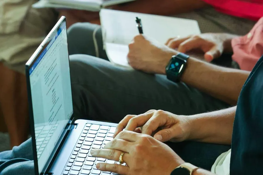 Hands typing on laptop