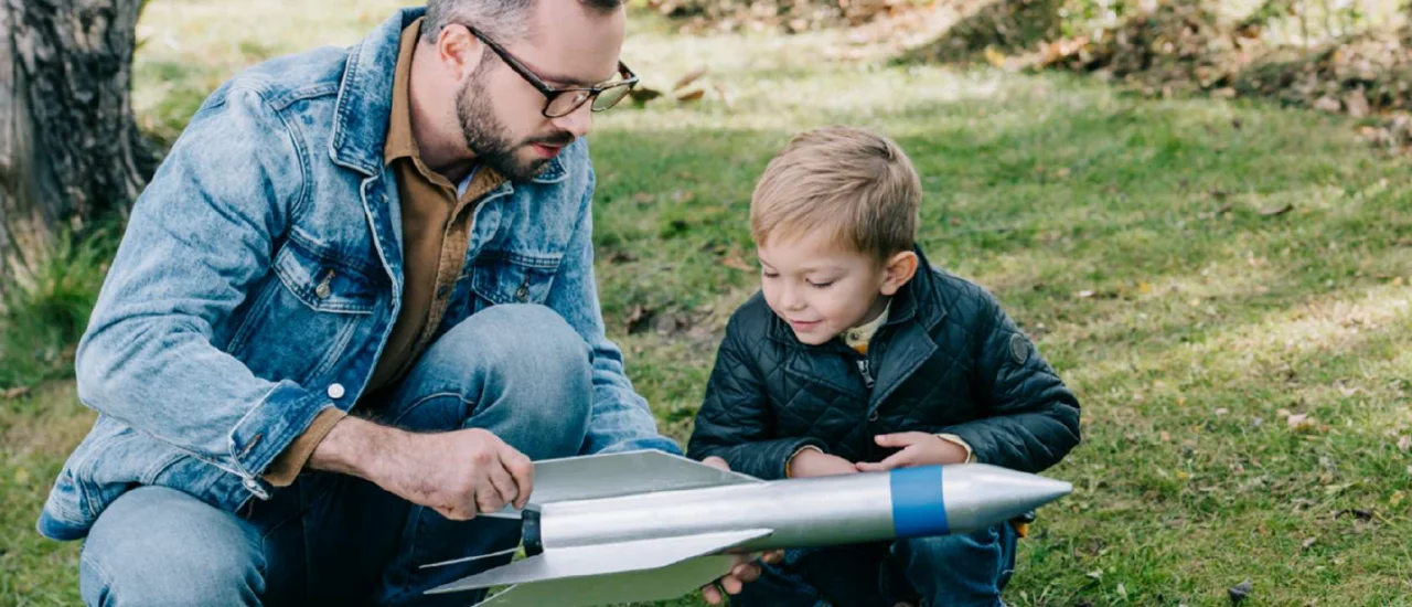 A father and son working together on a rocket ship