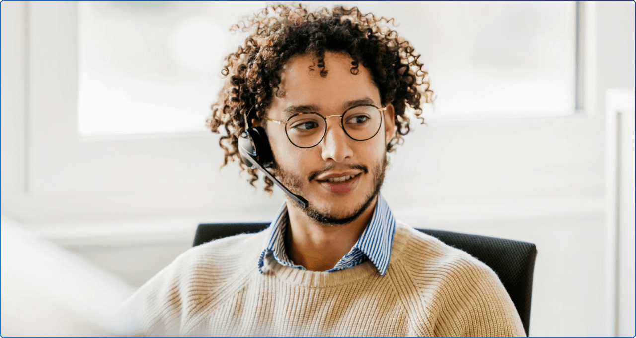 Picture of a young man talking into a eadset