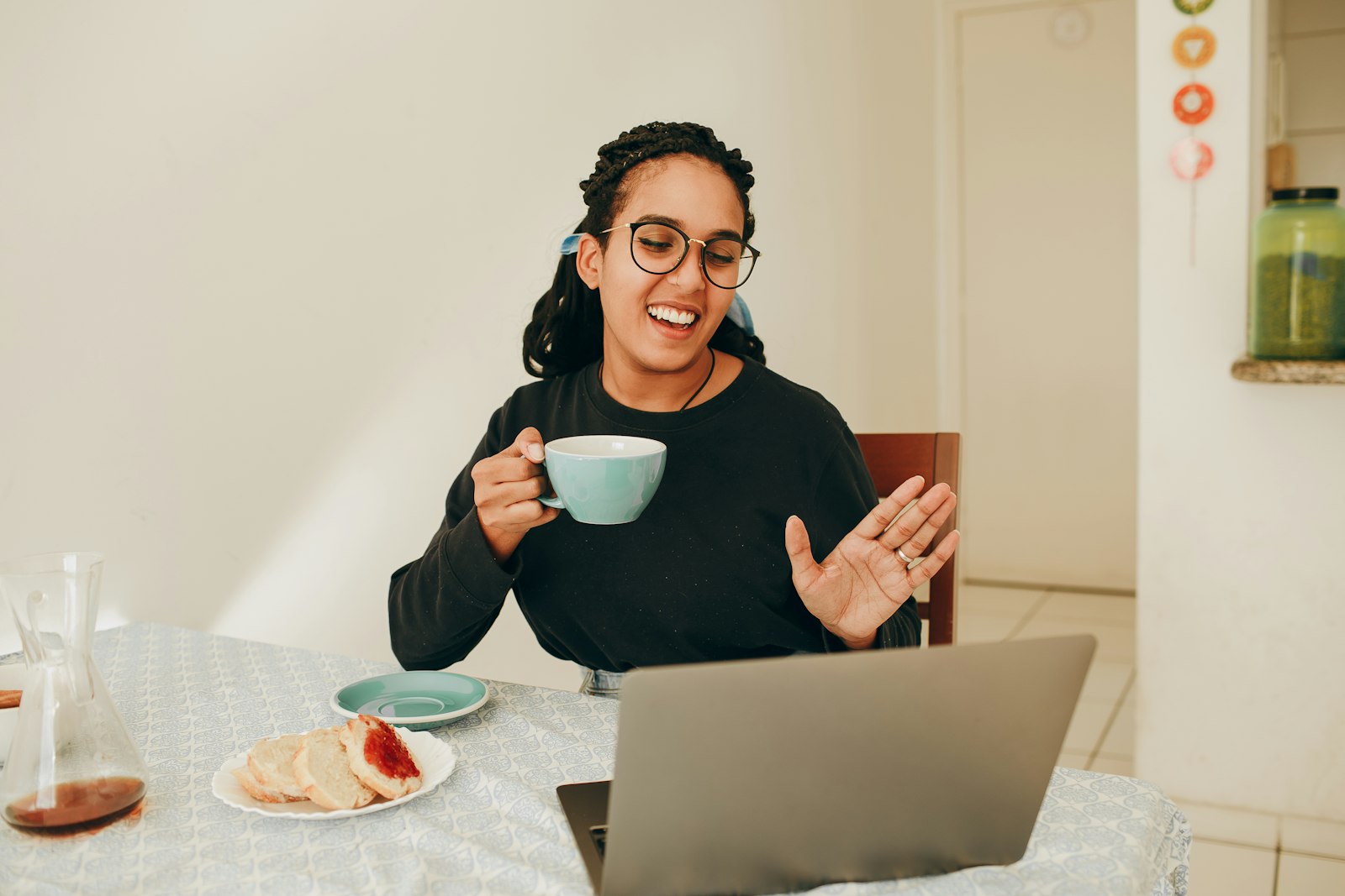 Employee smiling at her laptop while reviewing an on brand company video